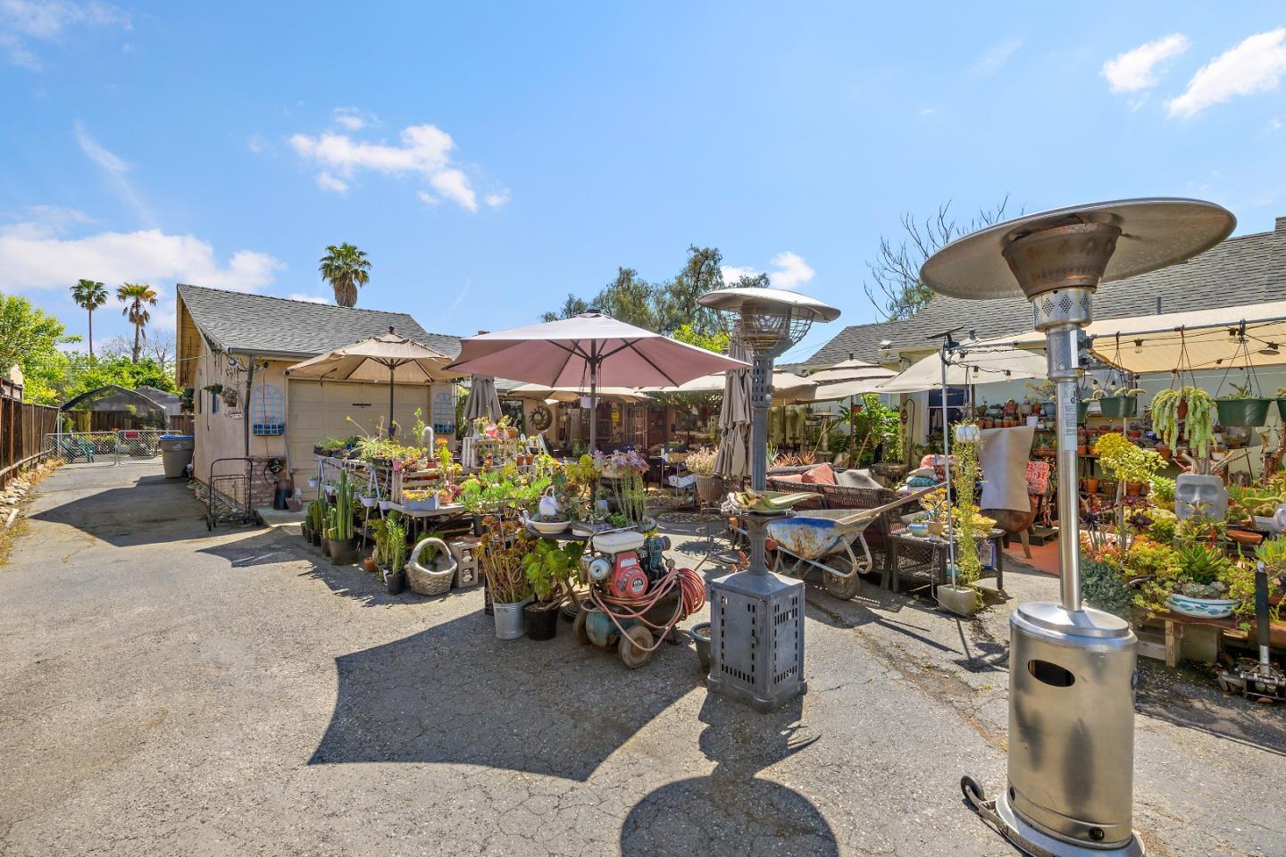 310 Lewis Road San Jose, CA 95111 - Photo 19 of 27 a view of a patio with dining table and chairs under an umbrella