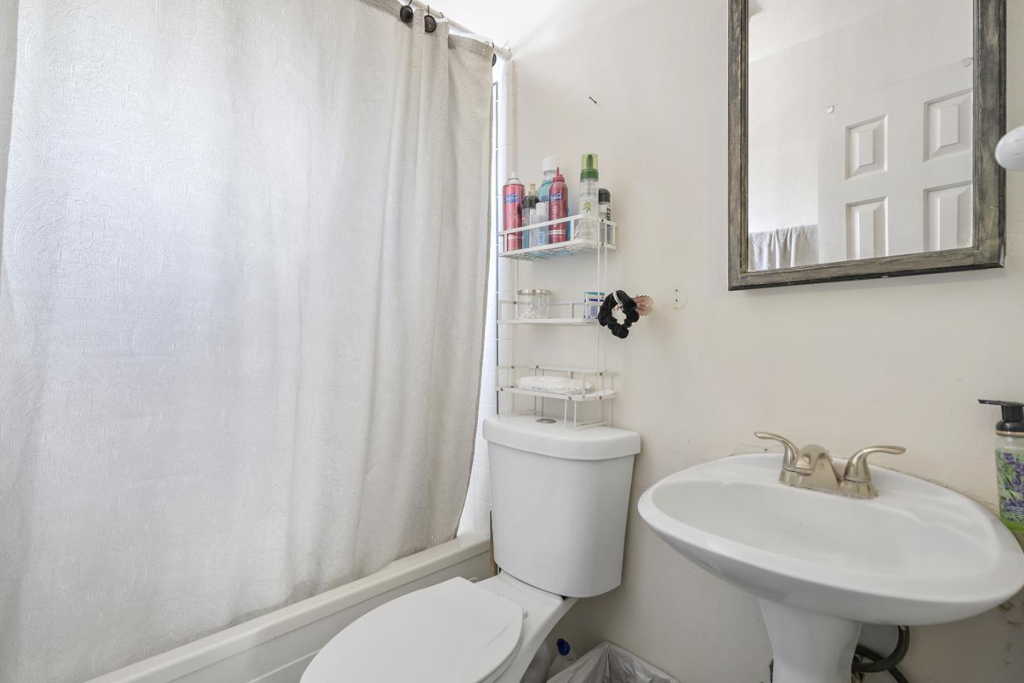 310 Lewis Road San Jose, CA 95111 - Photo 9 of 27 a bathroom with a sink toilet and a mirror