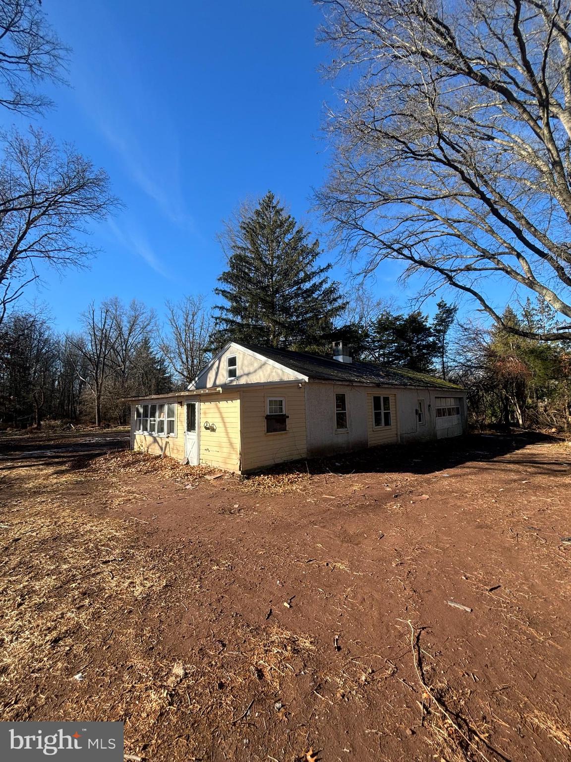 a backyard of a house with large trees