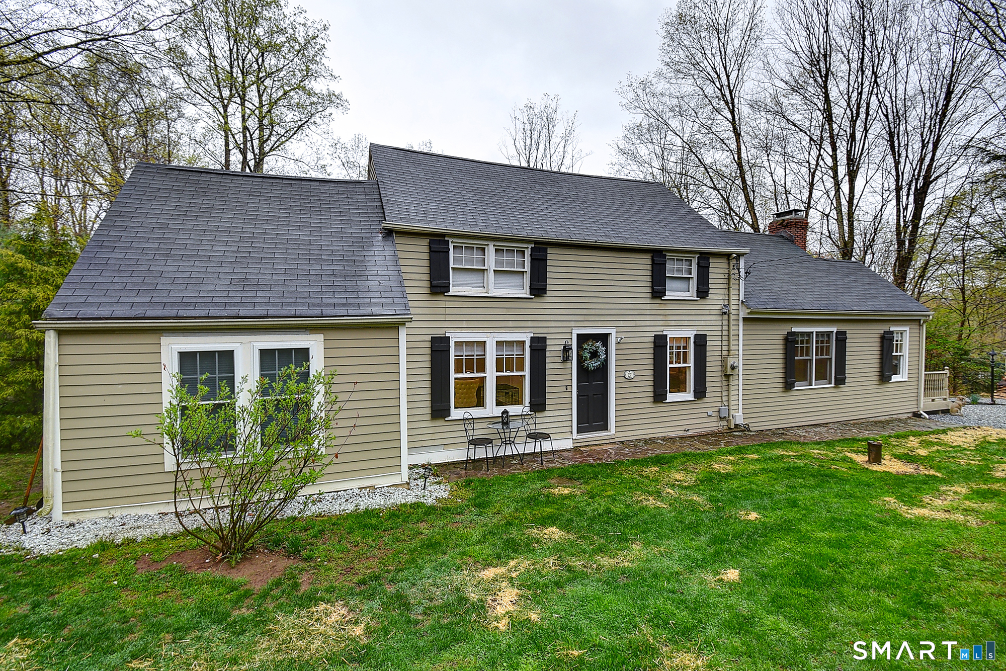 27 Chestnut Hill Road Newtown, CT 06482 - Photo 2 of 36 a front view of a house with a yard and trees