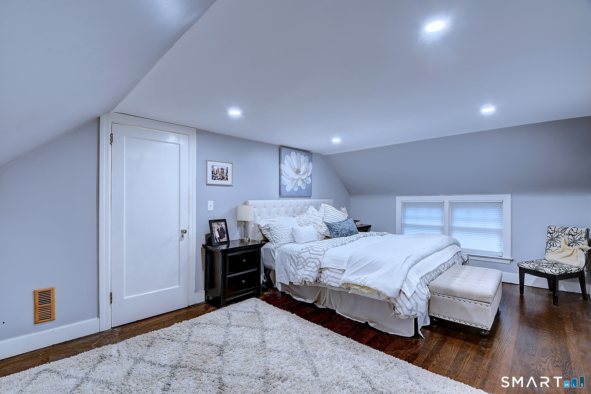 27 Chestnut Hill Road Newtown, CT 06482 - Photo 26 of 36 a bedroom with a bed and wooden floor