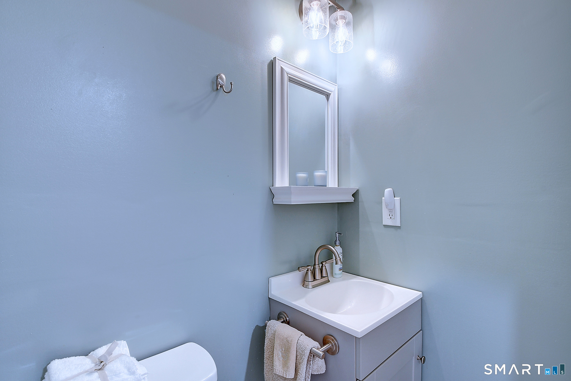 27 Chestnut Hill Road Newtown, CT 06482 - Photo 35 of 36 a bathroom with a toilet sink and mirror