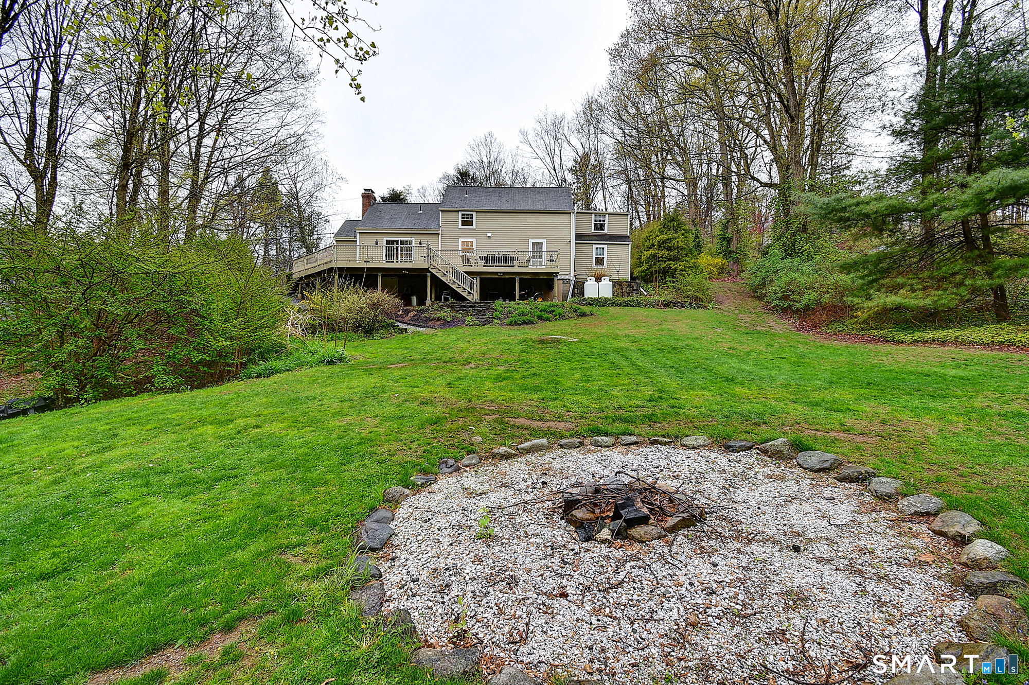 27 Chestnut Hill Road Newtown, CT 06482 - Photo 6 of 36 a front view of a house with a garden and yard