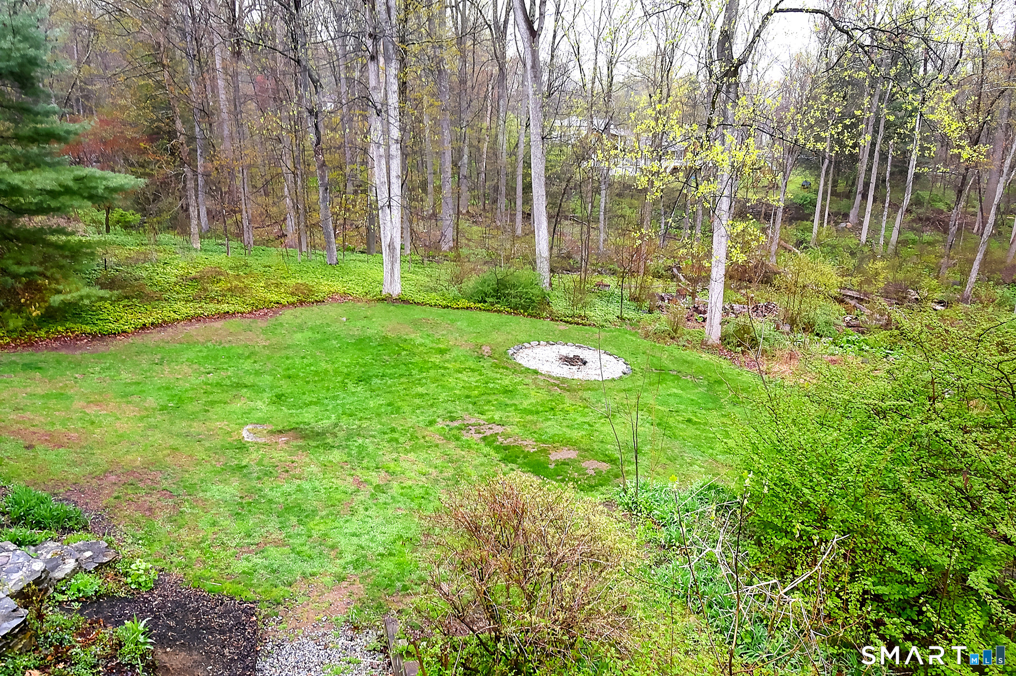 27 Chestnut Hill Road Newtown, CT 06482 - Photo 9 of 36 a view of a backyard with table and chairs and wooden fence