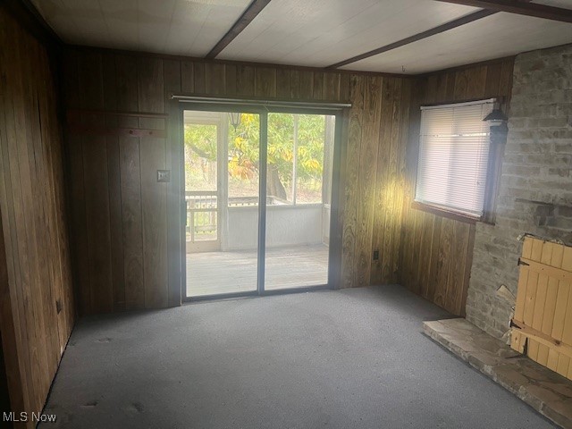 3035 Slack Road Mount Perry, OH 43760 - Photo 10 of 24 Unfurnished living room featuring carpet flooring, healthy amount of natural light, and wood walls