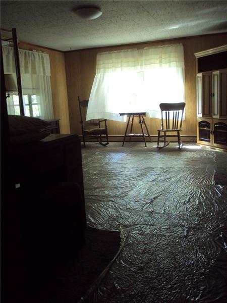 35 Hewitt Road West Middlesex, PA 16159 - Photo 6 of 25 View of the living room from hallway (plastic on new carpet to protect it)