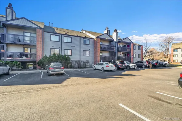 a view of a building with cars park