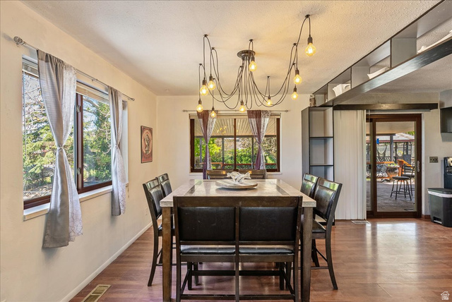 11 South Clark Lane Elk Ridge, UT 84651 - Photo 7 of 46 Dining space featuring dark wood finished floors, suspended lighting, and a textured ceiling