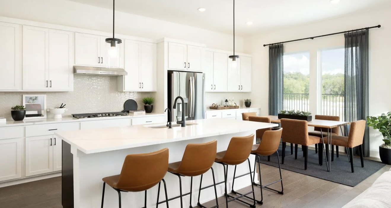 1405 Sweet Bark Street Austin, TX 78745 - Photo 4 of 11 a large kitchen with kitchen island a table and chairs