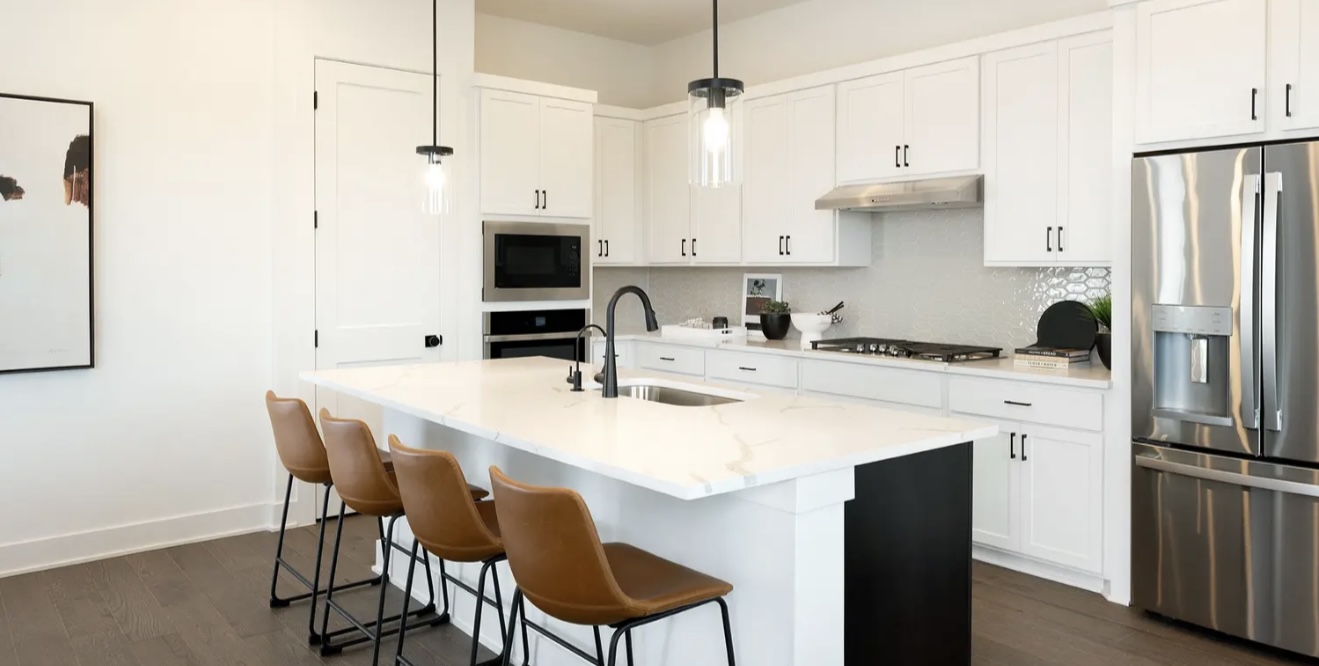 1405 Sweet Bark Street Austin, TX 78745 - Photo 5 of 11 a kitchen with stainless steel appliances a sink a stove a refrigerator and island