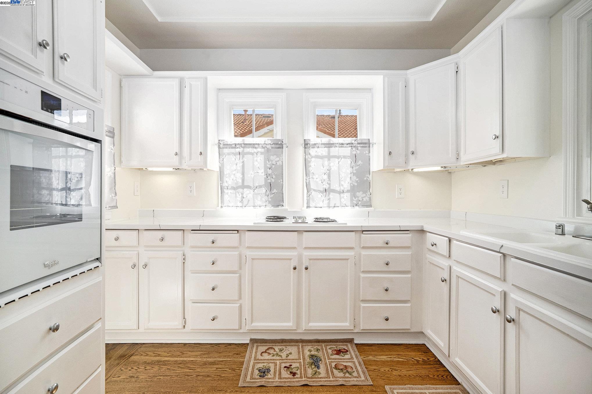 366 Ilo Lane Danville, CA 94526 - Photo 12 of 36 a kitchen with granite countertop white cabinets and white appliances