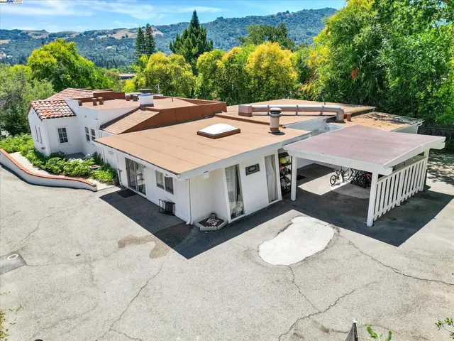 an aerial view of a house with a yard balcony