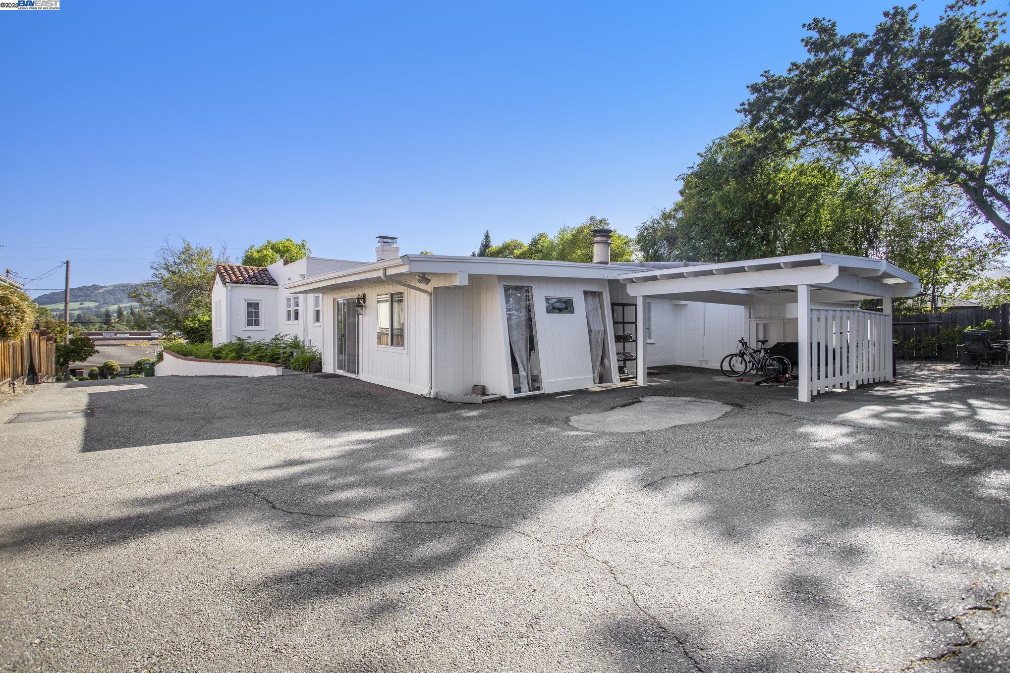 366 Ilo Lane Danville, CA 94526 - Photo 24 of 36 a view of a white house with a large space and a car parked in front of it