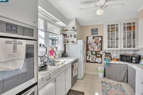 a view of a kitchen with fridge and workspace