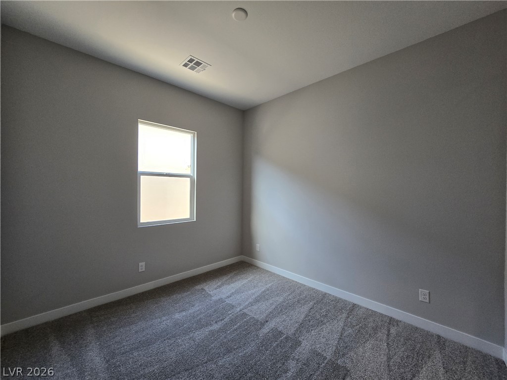852 Weston Ridge Street Henderson, NV 89011 - Photo 8 of 28 A well-proportioned bedroom with new carpeting and a sun-filled window awaits.