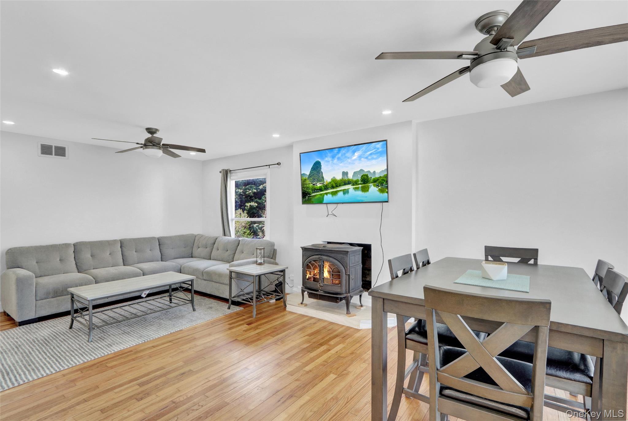 25 Wildwood Road Rocky Point, NY 11778 - Photo 16 of 47 a living room with fireplace furniture and a wooden floor