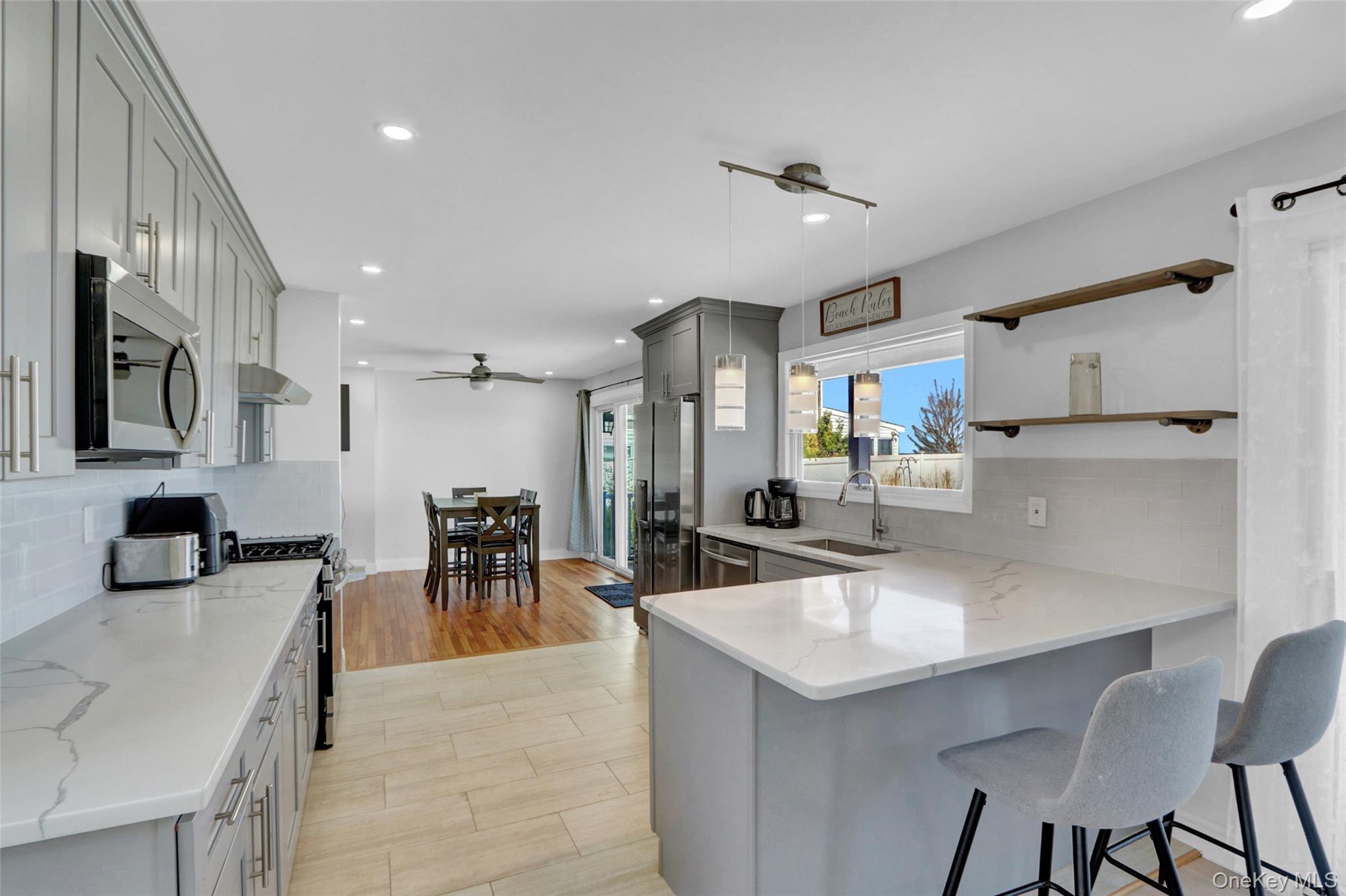 25 Wildwood Road Rocky Point, NY 11778 - Photo 20 of 47 a kitchen with stainless steel appliances kitchen island granite countertop a sink and cabinets