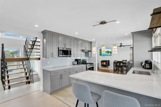 a kitchen with counter top space cabinets and appliances