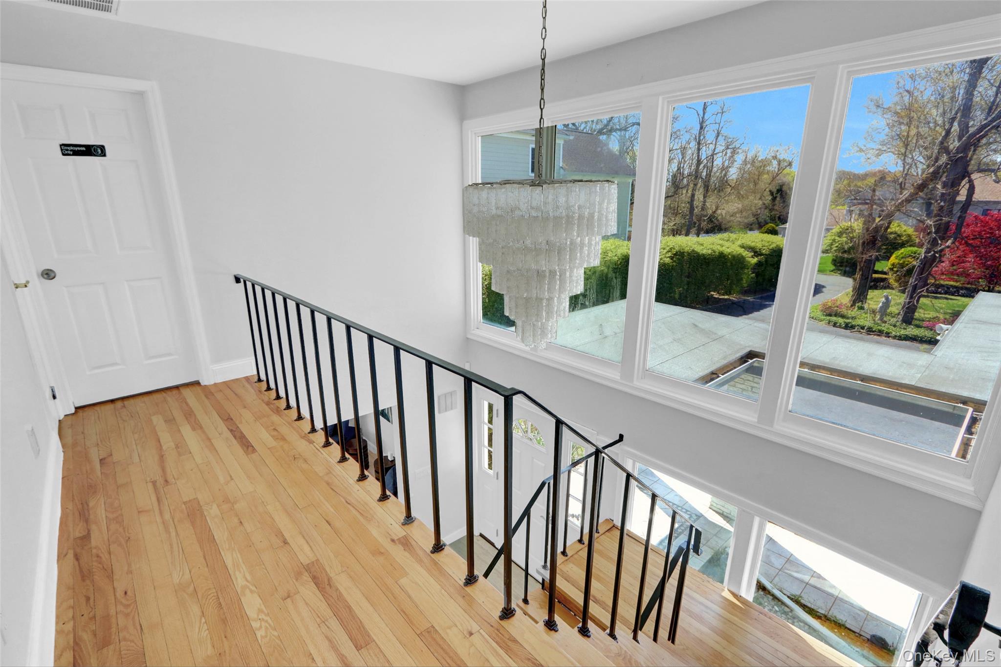 25 Wildwood Road Rocky Point, NY 11778 - Photo 31 of 47 a view of a hallway with wooden floor and chandelier