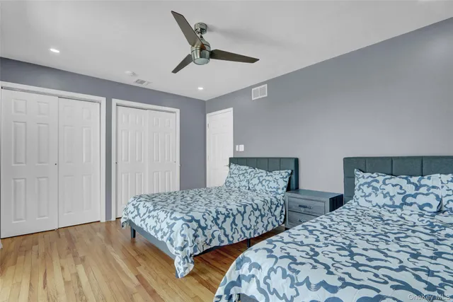 a bedroom with two beds and painting on the wall