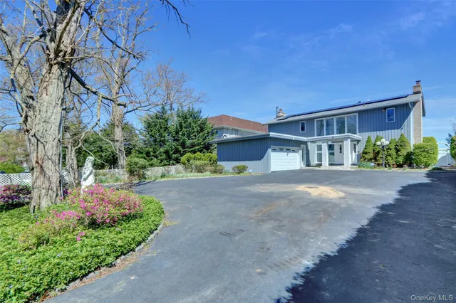 a front view of a house with a yard and a garage