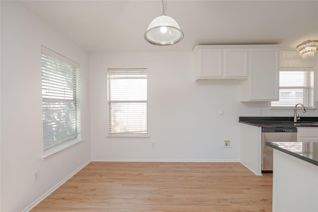 2912 Lighthouse Drive Denton, TX 76210 - Photo 13 of 34 a kitchen with granite countertop a stove a sink and a window