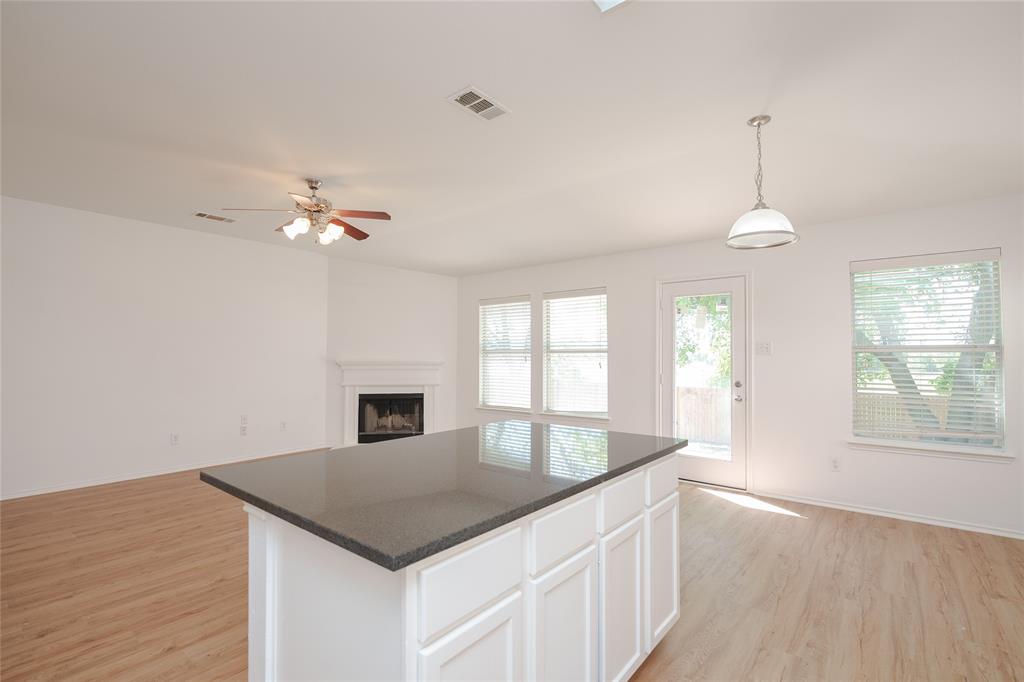2912 Lighthouse Drive Denton, TX 76210 - Photo 15 of 34 a kitchen with a stove a sink and chandelier