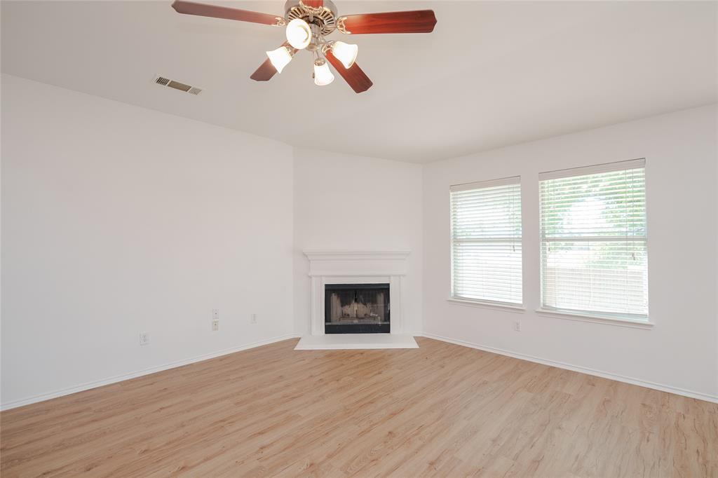 2912 Lighthouse Drive Denton, TX 76210 - Photo 16 of 34 an empty room with chandelier fan and windows