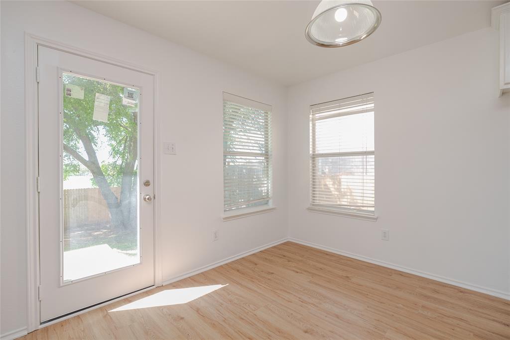 2912 Lighthouse Drive Denton, TX 76210 - Photo 17 of 34 an empty room with wooden floor and windows
