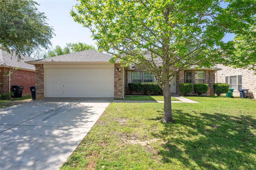 2912 Lighthouse Drive Denton, TX 76210 - Photo 2 of 34 a backyard of a house with plants and large tree