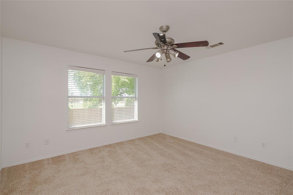 2912 Lighthouse Drive Denton, TX 76210 - Photo 23 of 34 an empty room with a window and a fan