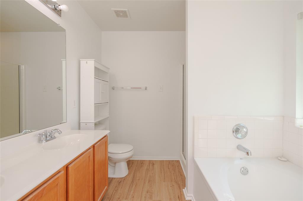 2912 Lighthouse Drive Denton, TX 76210 - Photo 24 of 34 a bathroom with a sink a toilet and shower