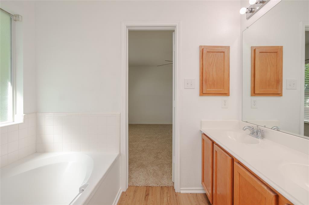 2912 Lighthouse Drive Denton, TX 76210 - Photo 26 of 34 a bathroom with a bathtub sink and mirror
