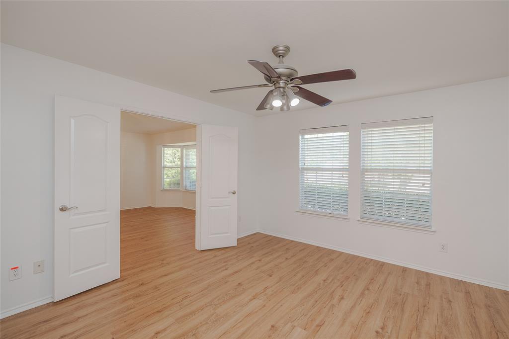 2912 Lighthouse Drive Denton, TX 76210 - Photo 27 of 34 an empty room with wooden floor fan and windows