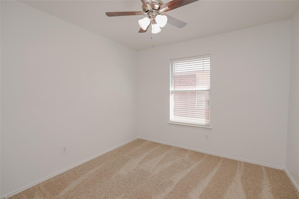 2912 Lighthouse Drive Denton, TX 76210 - Photo 29 of 34 an empty room with a window and a fan