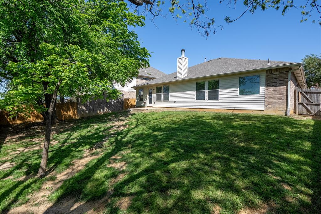 2912 Lighthouse Drive Denton, TX 76210 - Photo 33 of 34 a front view of a house with a garden