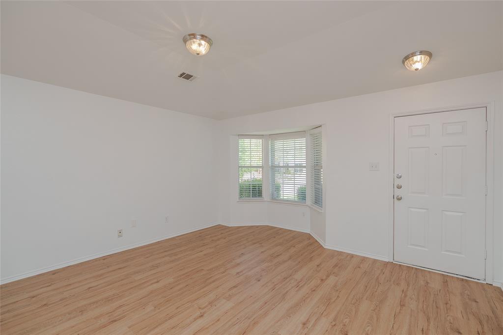 2912 Lighthouse Drive Denton, TX 76210 - Photo 5 of 34 wooden floor in an empty room with a window