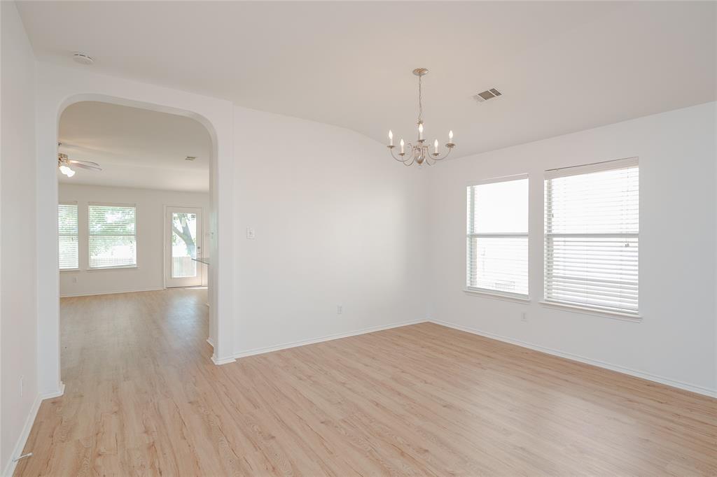 2912 Lighthouse Drive Denton, TX 76210 - Photo 10 of 34 an empty room with wooden floor and windows