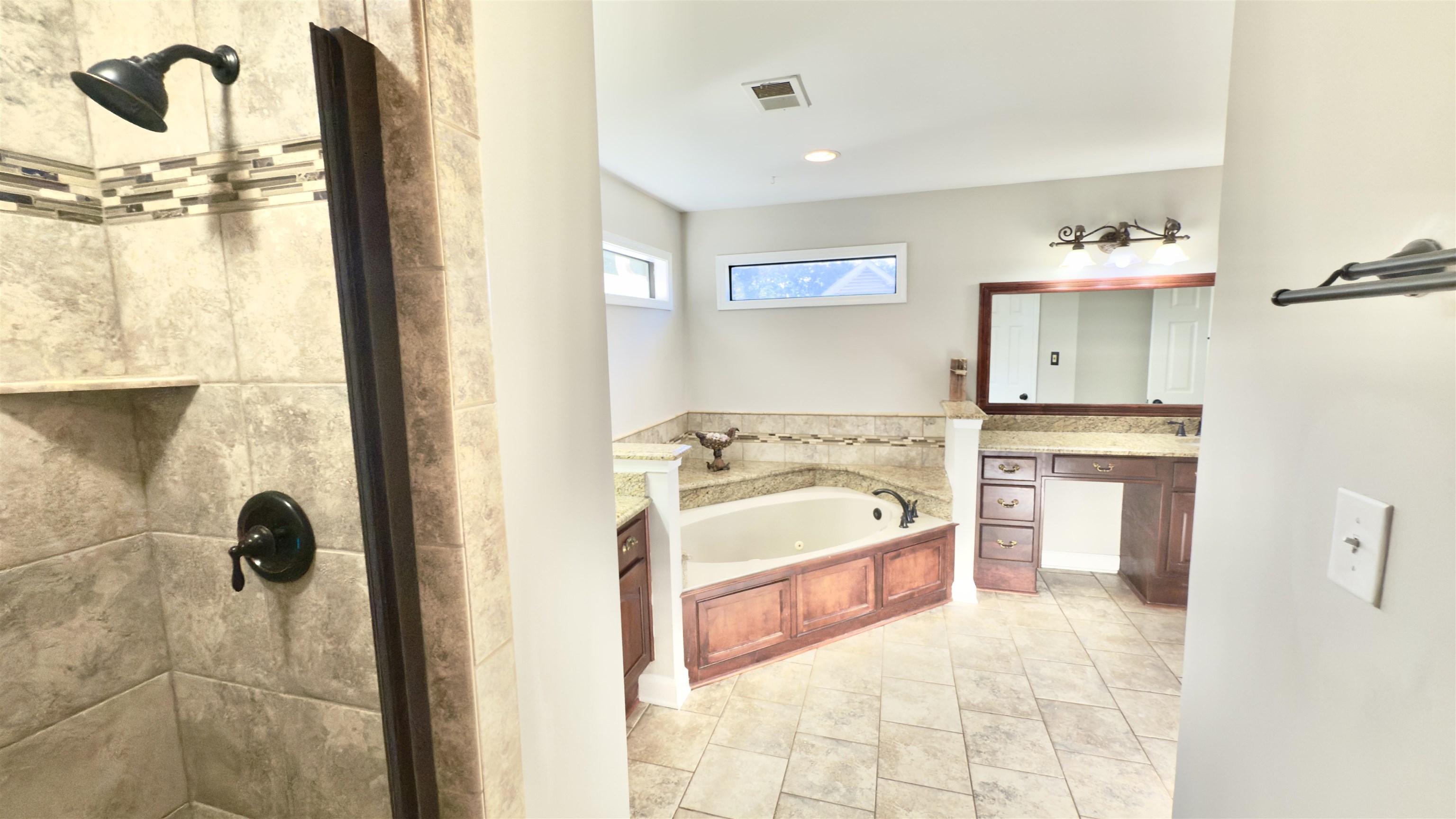 623 Winford Drive Collierville, TN 38017 - Photo 15 of 22 a spacious bathroom with a tub sink and mirror