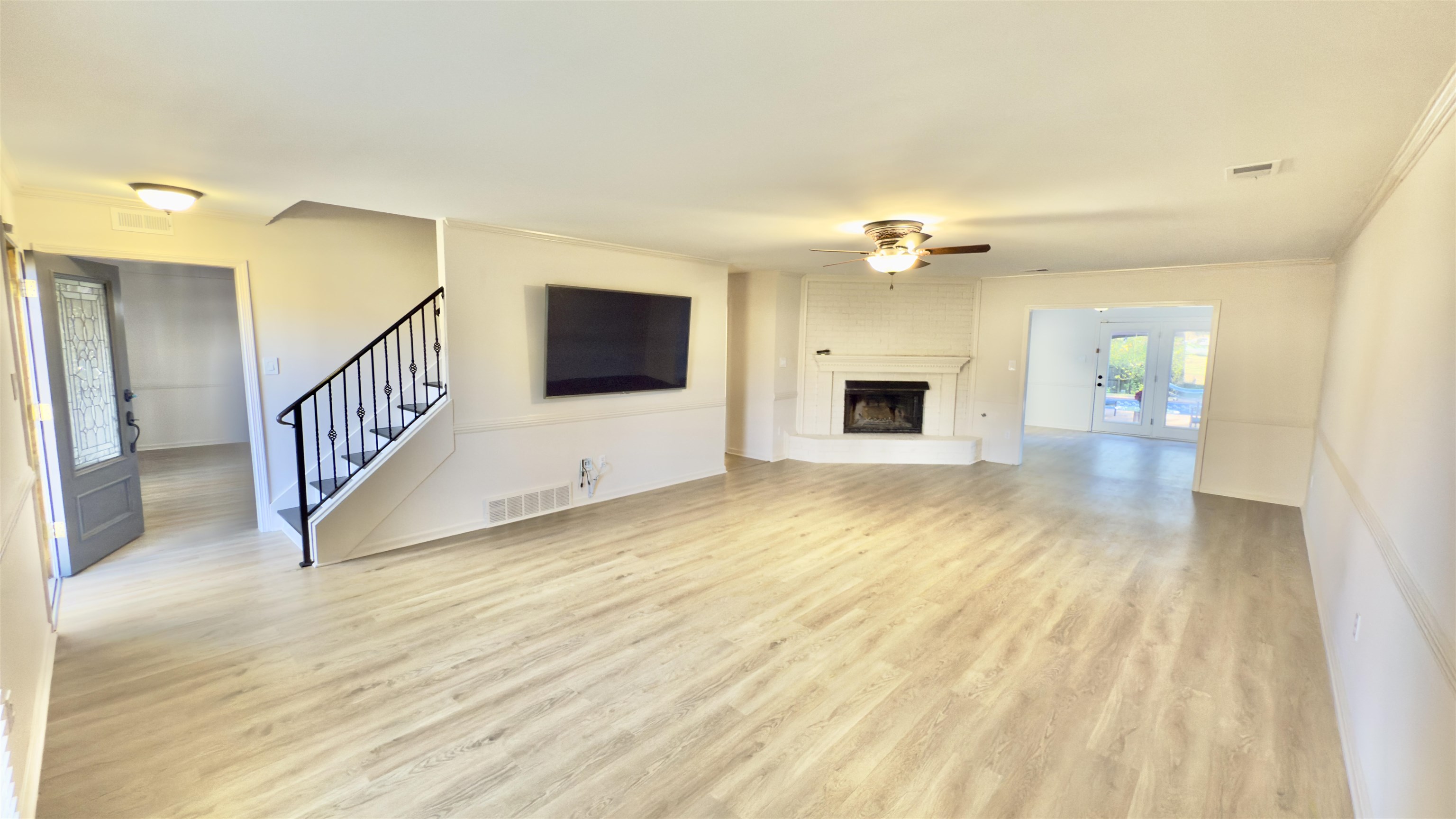623 Winford Drive Collierville, TN 38017 - Photo 3 of 22 a view of a livingroom with wooden floor a fireplace and entryway