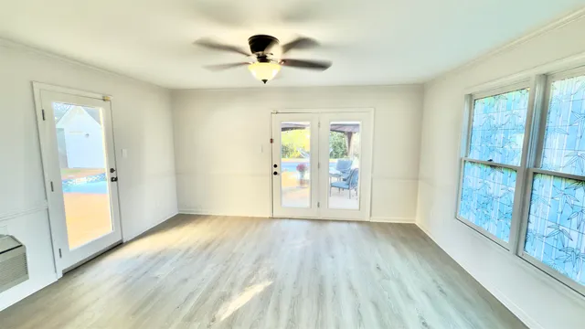 wooden floor in an empty room with a window