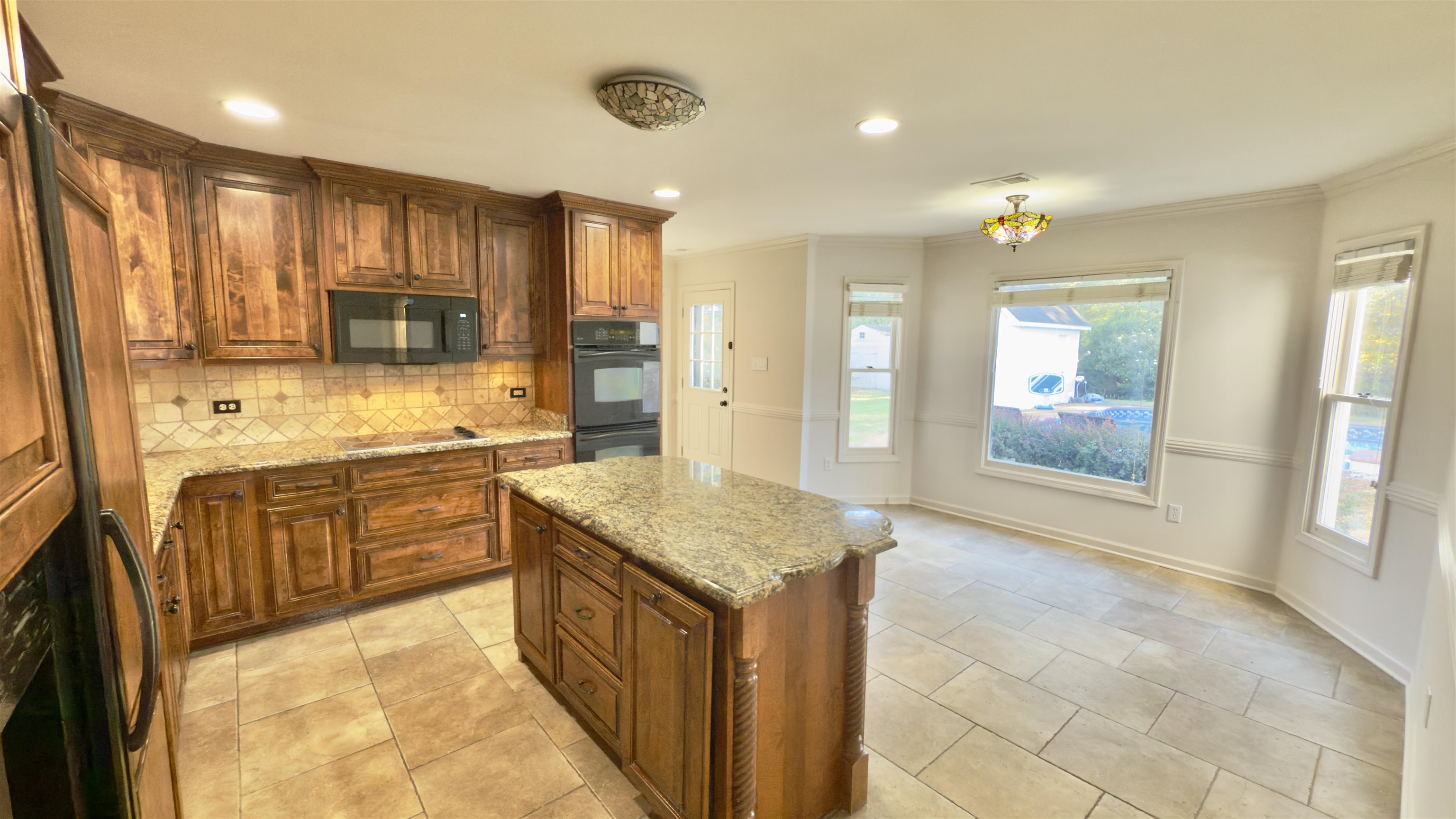 623 Winford Drive Collierville, TN 38017 - Photo 9 of 22 a kitchen with stainless steel appliances granite countertop a refrigerator a sink dishwasher and wooden cabinets with wooden floor
