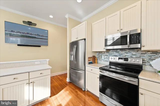 a kitchen with granite countertop a refrigerator stove and microwave
