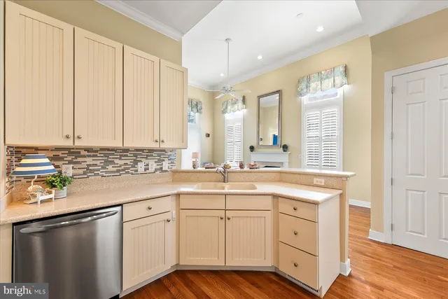 a kitchen with white cabinets and sink