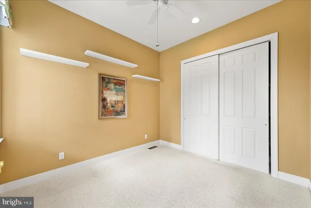 a view of an empty room with a ceiling fan