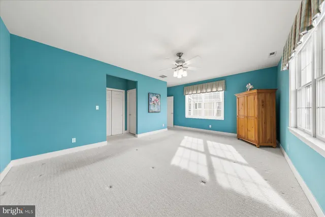 a view of an empty room with windows