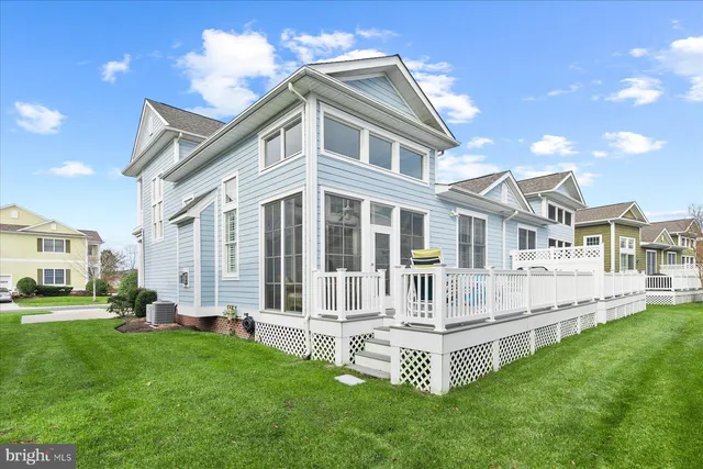 a white house with a big yard and more windows