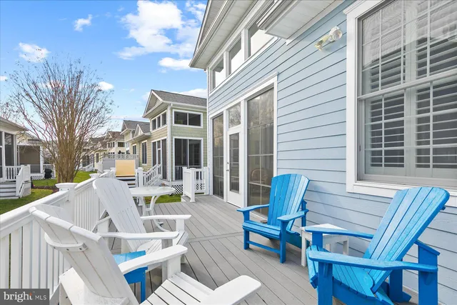 a view of a patio with table and chairs and wooden fence