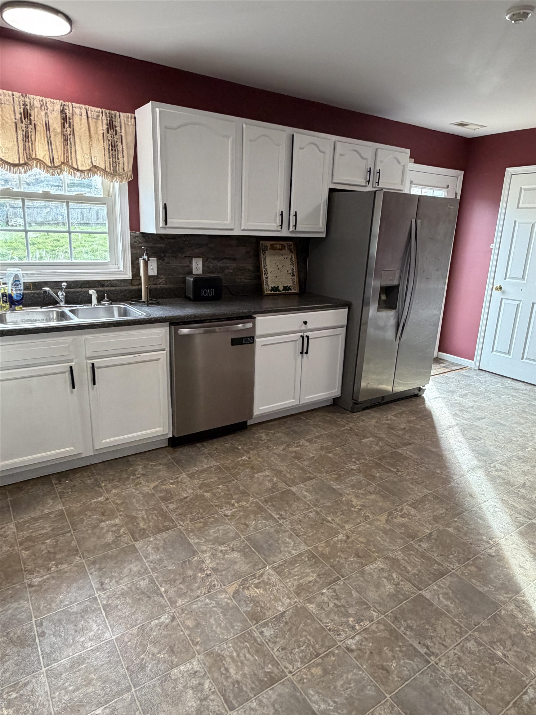 1520 3rd Street Waynesboro, VA 22980 - Photo 13 of 55 a kitchen with stainless steel appliances a refrigerator sink and cabinets