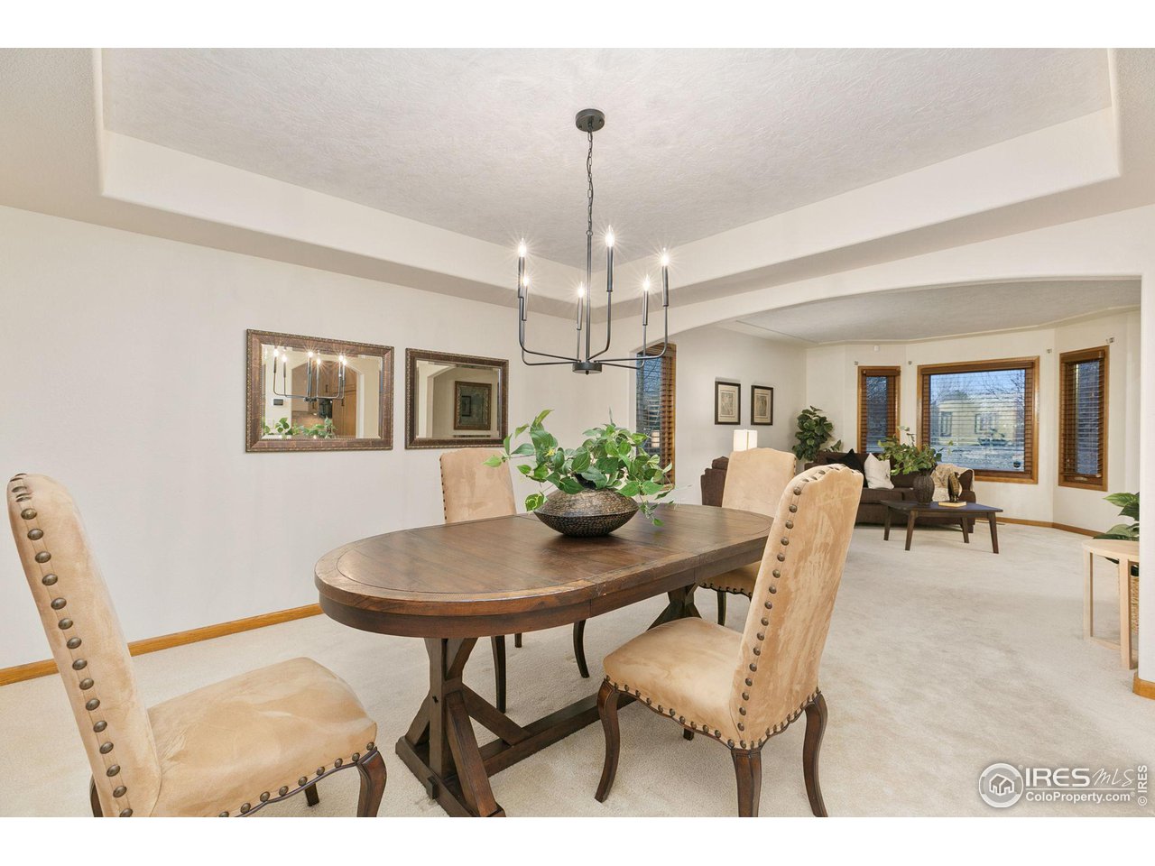 32593 Stagecoach Road Windsor, CO 80550 - Photo 18 of 28 a view of a dining room with furniture and chandelier